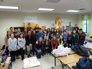 Lambert student volunteers pose for a photo at the end of a packing meeting.