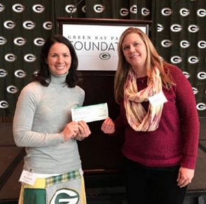 The Green Bay Packers Foundation presents a $2,000 check to the 