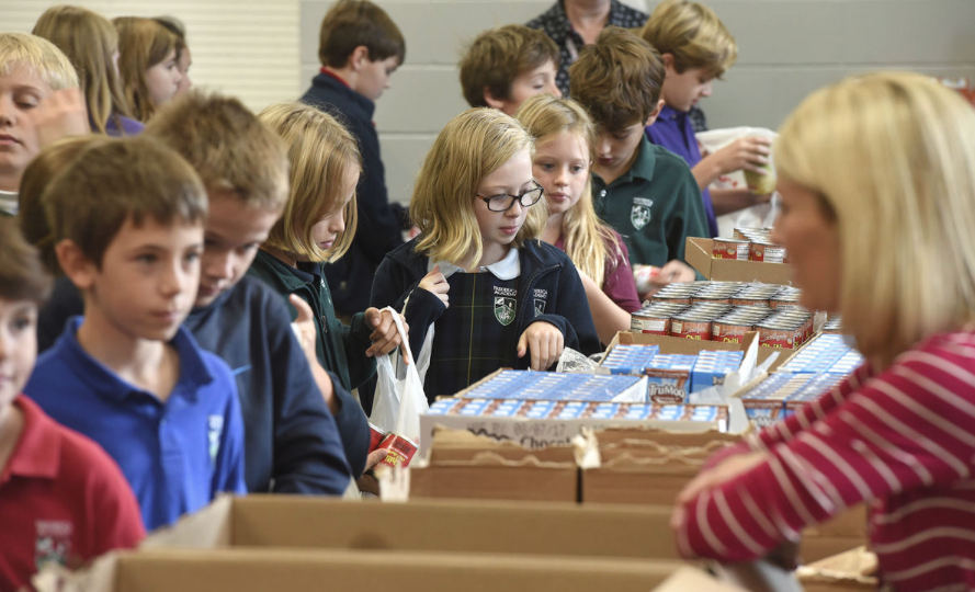 Frederica students help pack food with Blessings in a Backpack