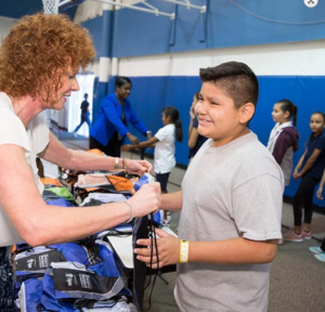 Boy accepting bag from a volunteer