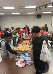 Garrison Mill students pack Blessings in a Backpack bags.