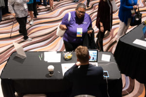 Volunteer Conference attendee talking with a conference worker