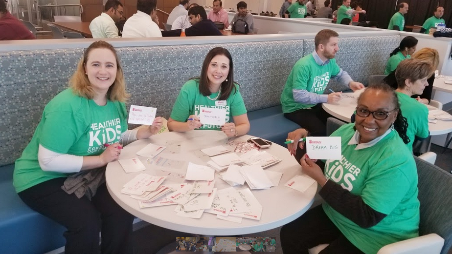 Cigna packing event Cigna employees writing note cards