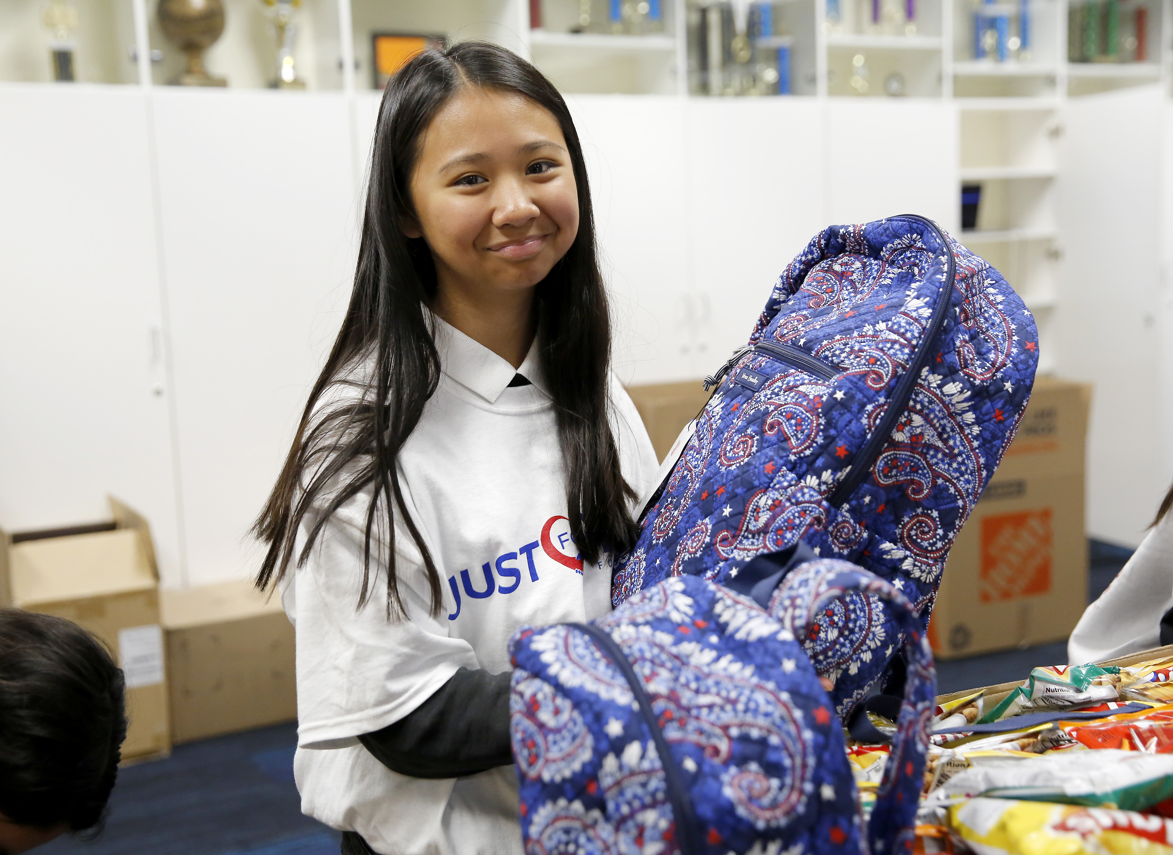 Young girl volunteering with blessings in a Backpack