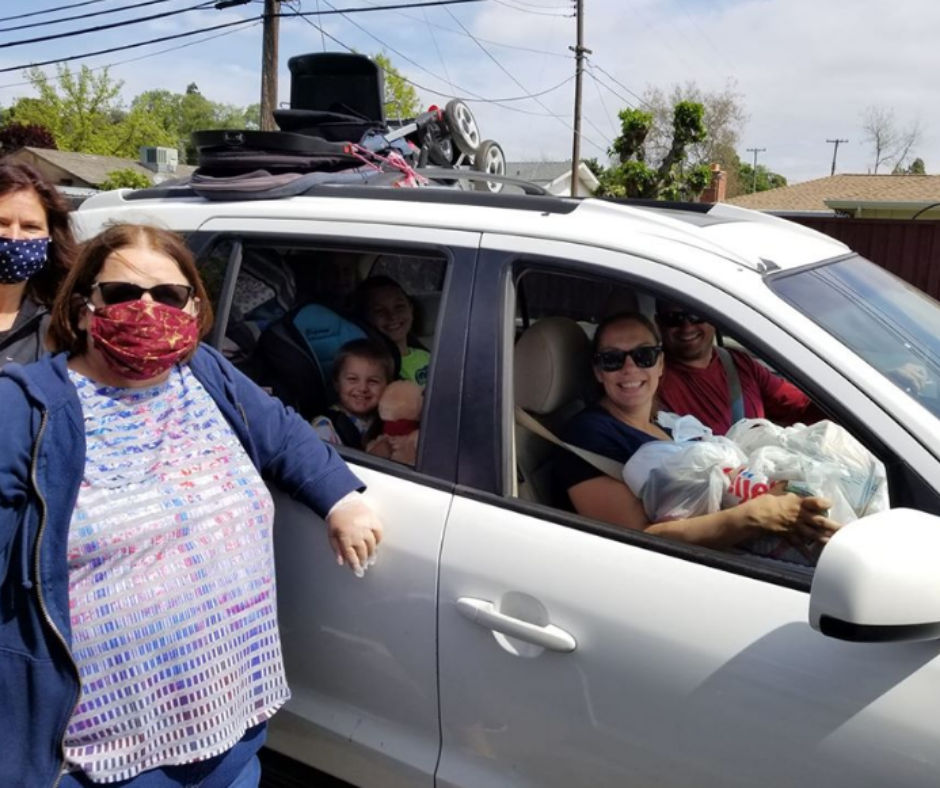 Family in a car picking up food in California