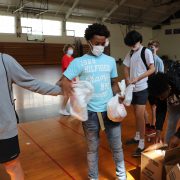 Students Utilize Money from Ravens Loss to Pack Bags of Food for Blessing in a Backpack