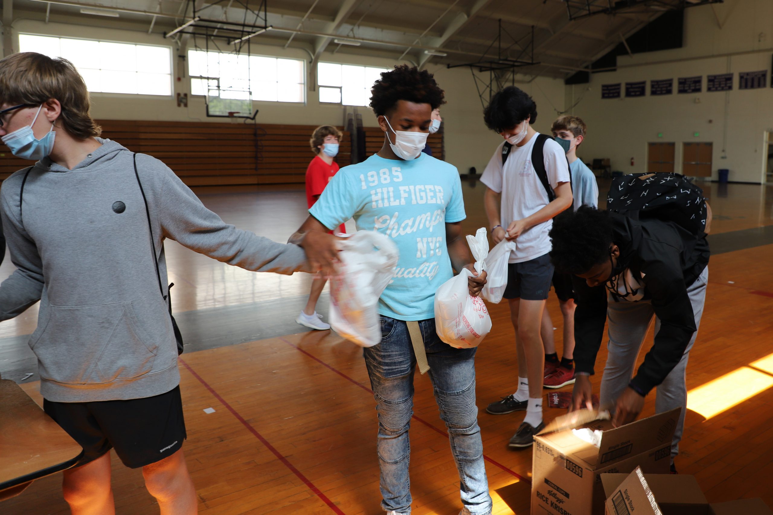Students Utilize Money from Ravens Loss to Pack Bags of Food for Blessing in a Backpack