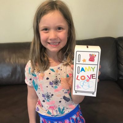 girl with decorated piggy bank