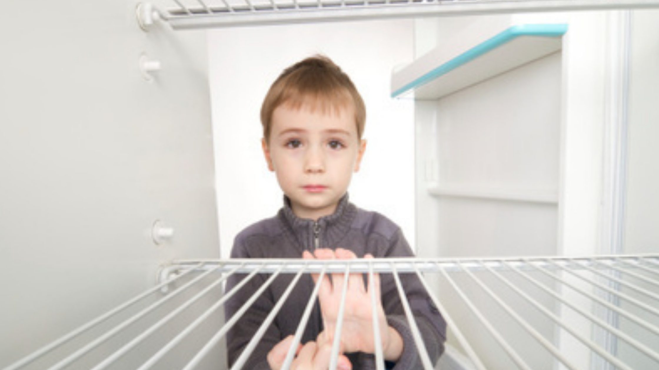Boy with empty fridge