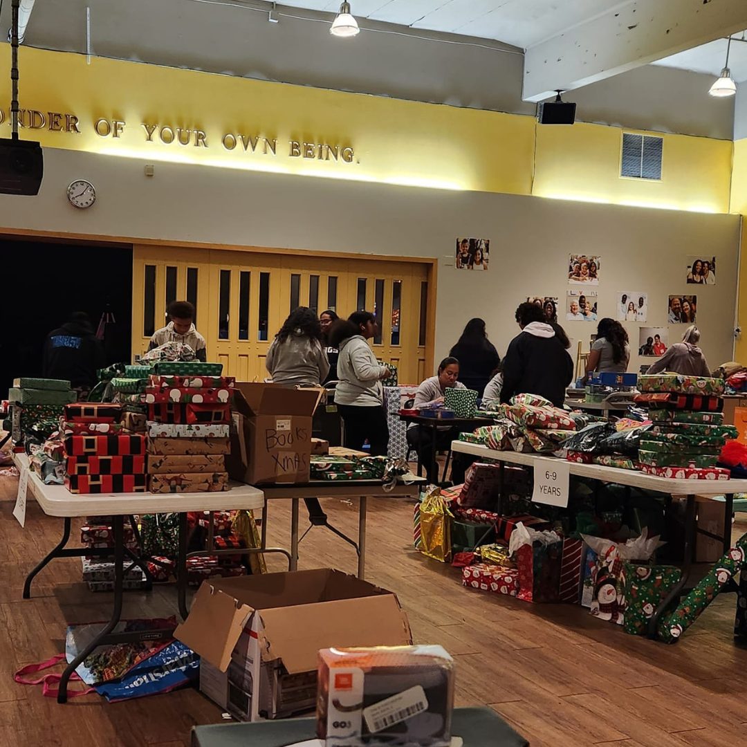 Teen volunteers wrapping toys