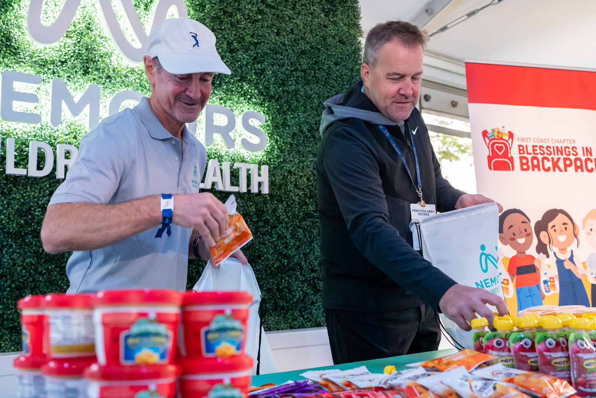 Nemours, Blessings in a Backpack, and Fuyrk volunteers pack food for kids