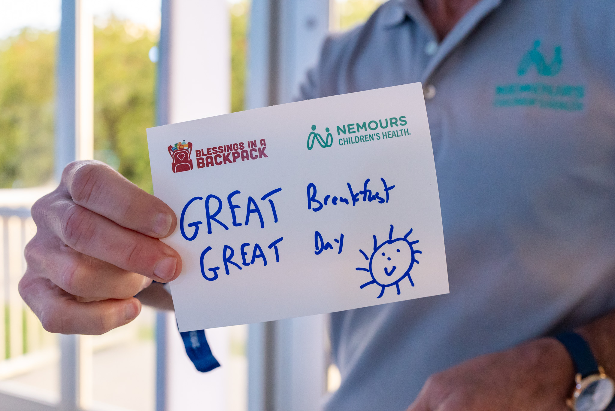 PGA golfers and volunteers writing note cards for kids