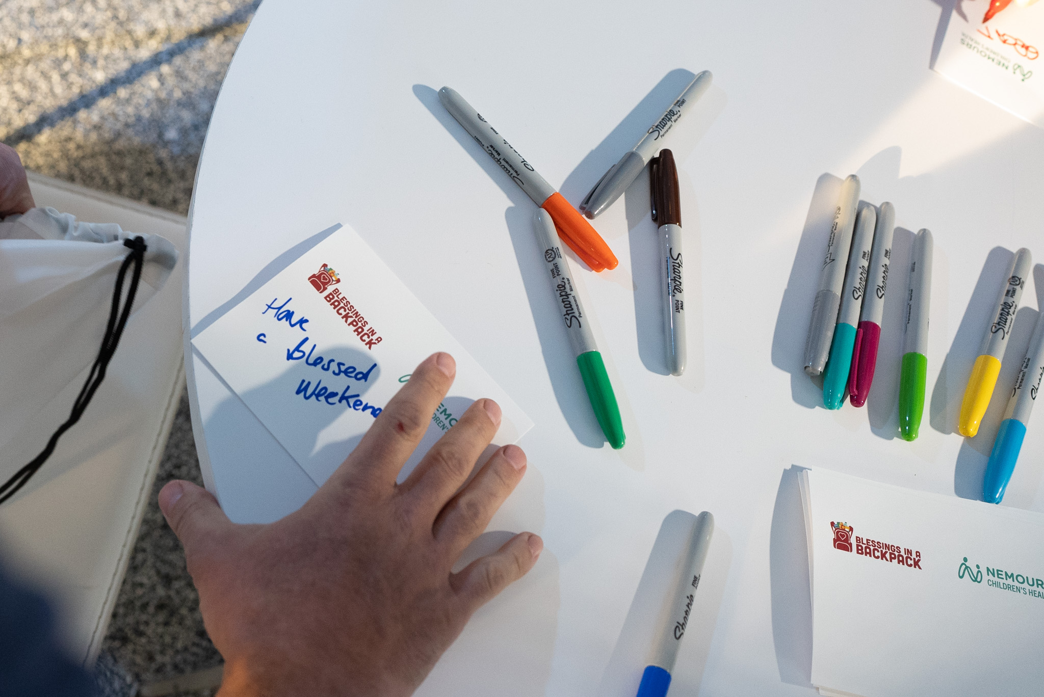 PGA golfers and volunteers writing note cards for kids