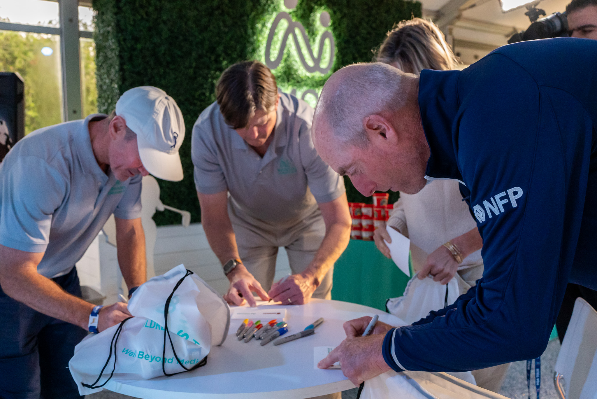 PGA players and volunteers writing note cards