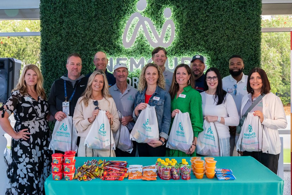 Nemours, Blessings in a Backpack, and Fuyrk volunteers pack food for kids