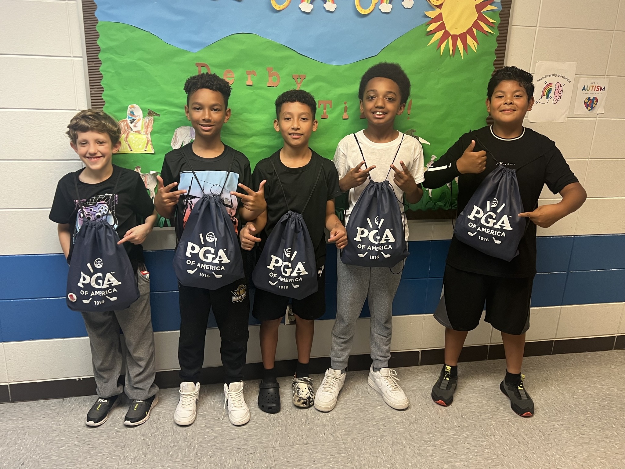 Kids smiling with PGA drawstring bags